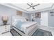 Bright main bedroom features tile floors, ceiling fan, and ensuite bathroom entrance at 26254 Stillwater Cir, Punta Gorda, FL 33955
