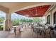 Covered outdoor patio offering dining tables, chairs, and a relaxing space with green views at 26254 Stillwater Cir, Punta Gorda, FL 33955
