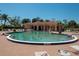A community pool, surrounded by lounge chairs and landscaping, offers a refreshing escape with a depth of 3 feet 8 inches at 26254 Stillwater Cir, Punta Gorda, FL 33955