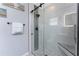 Modern glass-enclosed shower with gray tiling, pebble floor, and built-in niche at 26254 Stillwater Cir, Punta Gorda, FL 33955