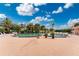 Beautiful outdoor swimming pool with brick patio, lounge chairs, and lush tropical landscaping at 26254 Stillwater Cir, Punta Gorda, FL 33955