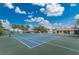 Well-maintained tennis court with new nets and beautiful landscaping on a sunny day at 26254 Stillwater Cir, Punta Gorda, FL 33955