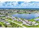 Breathtaking aerial view of a beautiful lakeside community boasting lush green spaces and inviting blue swimming pool at 26310 Rampart Blvd # 504, Punta Gorda, FL 33983