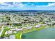 Aerial view of homes in lakeside community surrounded by lush greenery and calm lake waters at 26310 Rampart Blvd # 504, Punta Gorda, FL 33983