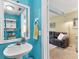 Bright bathroom featuring blue walls, stylish fixtures, and decorative accents at 26310 Rampart Blvd # 504, Punta Gorda, FL 33983