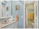 Bright bathroom with decorative starfish art, clean towels, and an adjacent toilet room at 26310 Rampart Blvd # 504, Punta Gorda, FL 33983