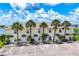 Charming condo exterior features a well-maintained façade with palm trees and dedicated parking spaces at 26310 Rampart Blvd # 504, Punta Gorda, FL 33983