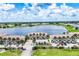 Exterior view of lakeside condos featuring meticulously maintained landscaping and ample parking at 26310 Rampart Blvd # 504, Punta Gorda, FL 33983