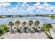Aerial view of waterfront condos surrounded by palm trees, a lake, and lush greenery at 26310 Rampart Blvd # 504, Punta Gorda, FL 33983