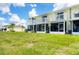 Charming two-story townhome featuring screened lanai and white railing balcony overlooking a well-manicured lawn at 26310 Rampart Blvd # 504, Punta Gorda, FL 33983