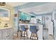 Kitchen area features a breakfast bar, bright lighting, and view of the entry at 26310 Rampart Blvd # 504, Punta Gorda, FL 33983