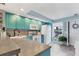 The turquoise kitchen offers modern appliances, ample counter space, and backyard views at 26310 Rampart Blvd # 504, Punta Gorda, FL 33983
