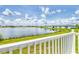 Scenic lake view from the balcony, with lush green surroundings and blue skies at 26310 Rampart Blvd # 504, Punta Gorda, FL 33983