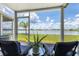 Outdoor lanai with view of the water, lush grass, and blue skies at 26310 Rampart Blvd # 504, Punta Gorda, FL 33983