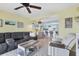 Open living room with comfortable seating, ceiling fan, and decorative accents at 26310 Rampart Blvd # 504, Punta Gorda, FL 33983