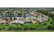 An aerial view of a community featuring homes near a scenic lake, blending natural beauty with residential charm at 2736 Suncoast Lakes Blvd, Punta Gorda, FL 33980