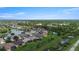 An aerial view of a community featuring homes near a lake with lush greenery and trees at 2736 Suncoast Lakes Blvd, Punta Gorda, FL 33980