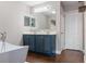 Modern bathroom features a double vanity, soaking tub, and stylish fixtures, offering a spa-like retreat at 2736 Suncoast Lakes Blvd, Punta Gorda, FL 33980