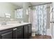 Bathroom features double sinks, dark cabinets, and a shower/tub combo at 2736 Suncoast Lakes Blvd, Punta Gorda, FL 33980
