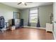 This bedroom with hardwood floors has a dresser, desk, and a window for natural light at 2736 Suncoast Lakes Blvd, Punta Gorda, FL 33980