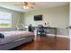 Bedroom features a window with natural light, ceiling fan, and a TV at 2736 Suncoast Lakes Blvd, Punta Gorda, FL 33980