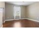 Bright bedroom features hardwood floors, neutral walls, large window with curtains, and ample natural light at 2736 Suncoast Lakes Blvd, Punta Gorda, FL 33980