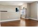 Bonus room with hardwood floors and neutral walls offers versatile space for relaxing or entertaining at 2736 Suncoast Lakes Blvd, Punta Gorda, FL 33980