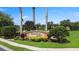 A well-maintained community entrance sign surrounded by lush landscaping welcomes residents and visitors at 2736 Suncoast Lakes Blvd, Punta Gorda, FL 33980