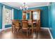 Inviting dining room features wood floors, a modern chandelier, and a dark wood table with seating for six at 2736 Suncoast Lakes Blvd, Punta Gorda, FL 33980