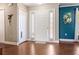 Bright entryway with white door, sidelights, and beautiful wood floors, leading to a welcoming home at 2736 Suncoast Lakes Blvd, Punta Gorda, FL 33980