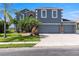 Charming two-story home featuring a three-car garage, well-manicured lawn, and beautiful landscaping at 2736 Suncoast Lakes Blvd, Punta Gorda, FL 33980