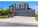 Charming blue two-story home featuring a three-car garage and lovely stone column accents at 2736 Suncoast Lakes Blvd, Punta Gorda, FL 33980