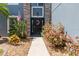 Charming front door flanked by colorful plants and stone accents at 2736 Suncoast Lakes Blvd, Punta Gorda, FL 33980