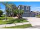 Charming two-story home featuring a three-car garage, well-manicured lawn, and mature landscaping at 2736 Suncoast Lakes Blvd, Punta Gorda, FL 33980