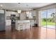 Open kitchen with island, pendant lighting, stainless steel appliances, and sliding doors to the backyard at 2736 Suncoast Lakes Blvd, Punta Gorda, FL 33980