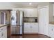 Modern kitchen with stainless steel refrigerator, granite countertops, and white cabinets, for a sleek design at 2736 Suncoast Lakes Blvd, Punta Gorda, FL 33980