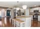 Open layout kitchen with center island, pendant lights, stainless appliances, and seamless access to other rooms at 2736 Suncoast Lakes Blvd, Punta Gorda, FL 33980
