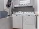 The laundry room has a washer, dryer, storage shelf and room for organizing at 2736 Suncoast Lakes Blvd, Punta Gorda, FL 33980