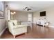 Cozy living room with wood floors, complemented by modern television and white storage cabinet at 2736 Suncoast Lakes Blvd, Punta Gorda, FL 33980
