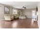 Bright living room features hardwood floors, neutral paint, and comfortable furnishings at 2736 Suncoast Lakes Blvd, Punta Gorda, FL 33980