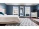 Spacious main bedroom featuring dark blue walls, hardwood floors, and bright natural light at 2736 Suncoast Lakes Blvd, Punta Gorda, FL 33980