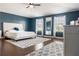 Spacious primary bedroom with hardwood floors, natural light, large bed, and modern ceiling fan at 2736 Suncoast Lakes Blvd, Punta Gorda, FL 33980