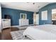 This main bedroom has plenty of space with a dresser and TV stand, ceiling fan and ensuite bathroom at 2736 Suncoast Lakes Blvd, Punta Gorda, FL 33980