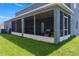 Screened-in patio with chairs and a small table offers a relaxing outdoor space at 2736 Suncoast Lakes Blvd, Punta Gorda, FL 33980