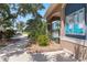 Landscaped pool entrance, complete with decorative rocks, and a bulletin board for community updates at 2736 Suncoast Lakes Blvd, Punta Gorda, FL 33980