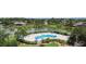 A serene community pool with ample seating and lush greenery, creating a relaxing oasis at 2736 Suncoast Lakes Blvd, Punta Gorda, FL 33980