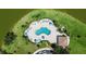 Aerial view of a community pool with plenty of seating and well manicured landscaping at 2736 Suncoast Lakes Blvd, Punta Gorda, FL 33980