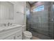 This renovated bathroom includes a glass shower and granite vanity at 28960 Gin Ln, Punta Gorda, FL 33982