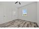 This bright bedroom features stylish wood-look floors, large closet, and a ceiling fan at 28960 Gin Ln, Punta Gorda, FL 33982