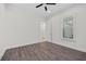 A simple bedroom with wood-look floors and a modern ceiling fan is ready for furnishings at 28960 Gin Ln, Punta Gorda, FL 33982